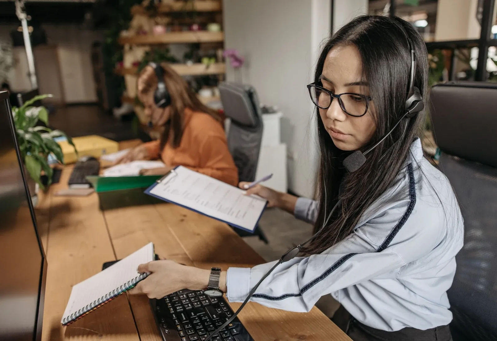 Medical billing professional reviewing paperwork at a workstation